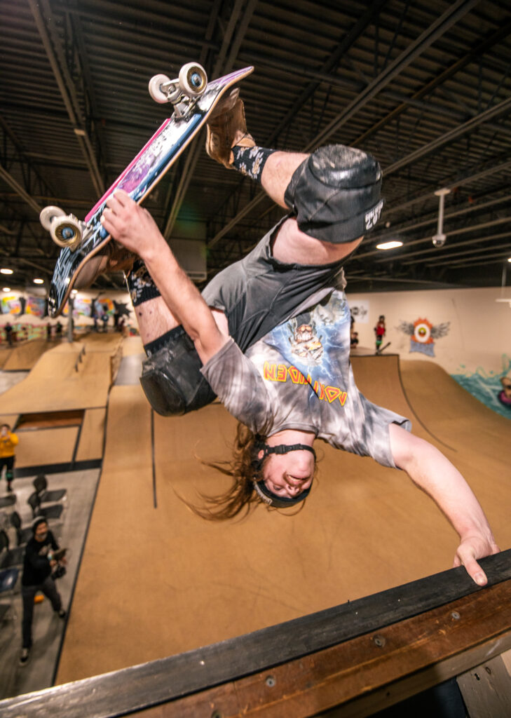 Dakota White going upside down with a hand plant on the vert