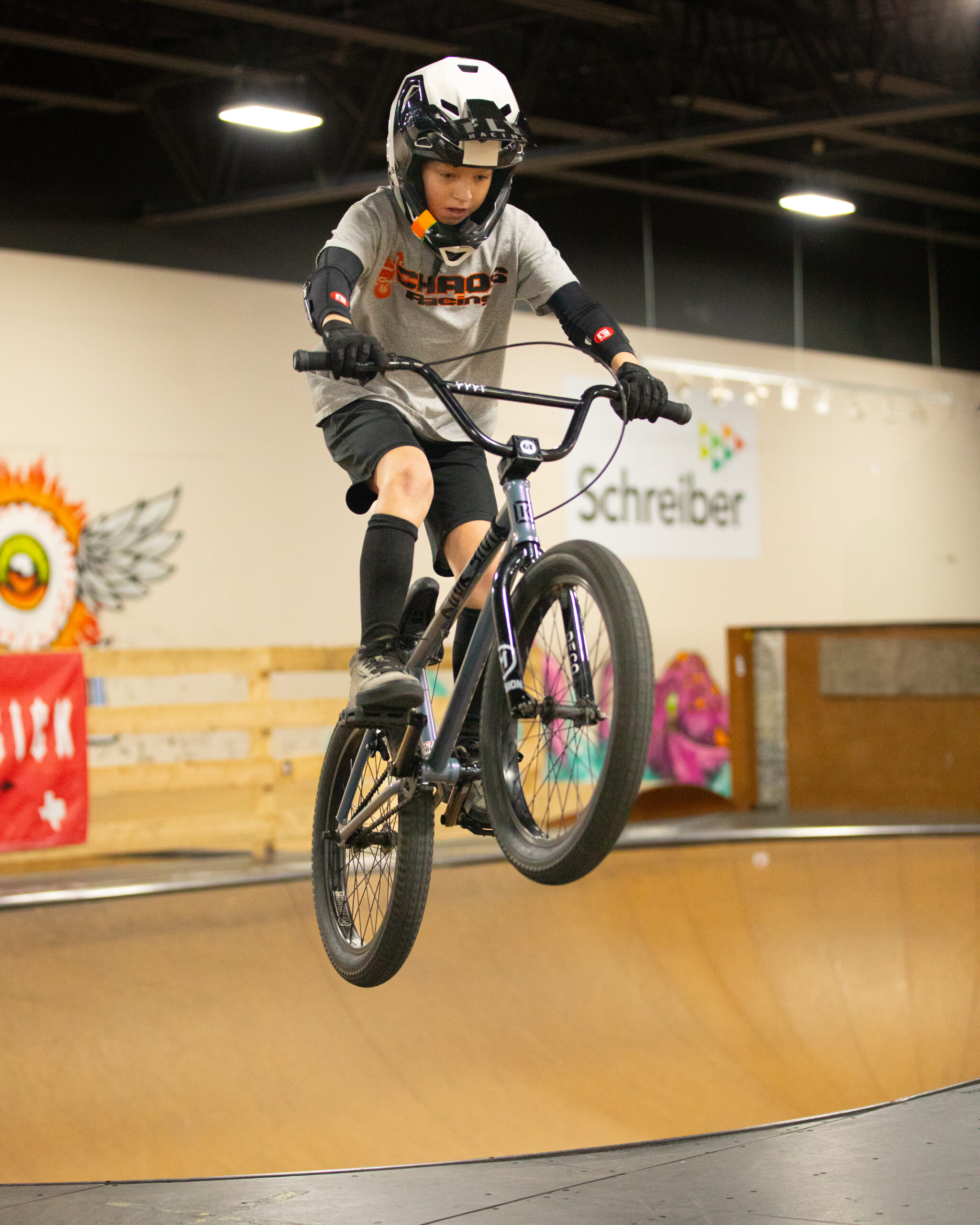 A young rider launches himself out of the bowl on his bike