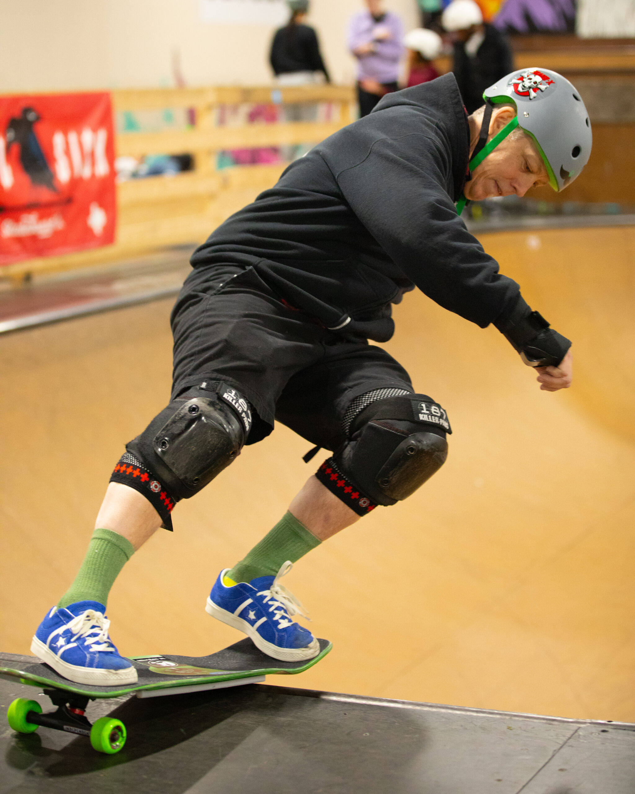 a skateboarder doing a trick on the coping of the bowl