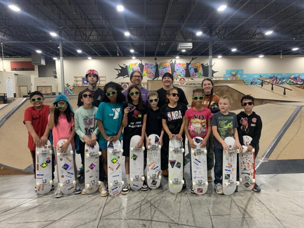 Students in the GBASO On Board Program pose with their skateboards