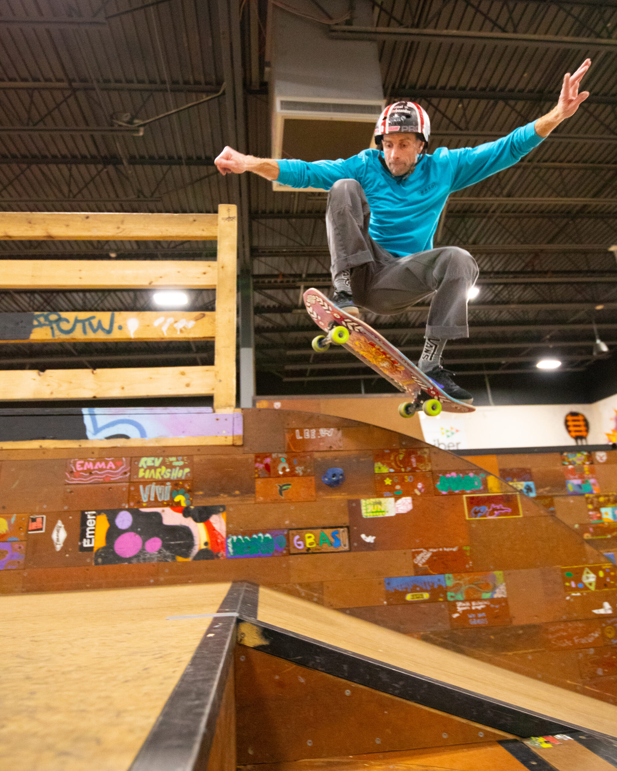 A skateboarder does an olly in the street section at GBASO